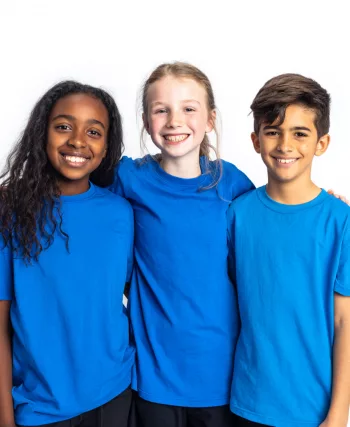 2 Avril Trois enfants souriants portant des t-shirts bleus pour la Journée mondiale de sensibilisation à l'autisme